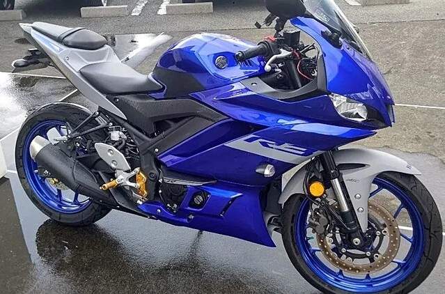 A blue Yamaha YZF-R3 learner approved motorbike parked, showcasing its sleek design and beginner-friendly features.