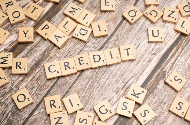 Scrabble tiles spelling out "CREDIT" on a wooden surface, highlighting the impact of your ABN car finance credit score.